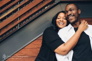 African American engaged couple hugging and laughing in Atlantic Station