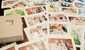 Large image box surrounded by matted prints and portraits