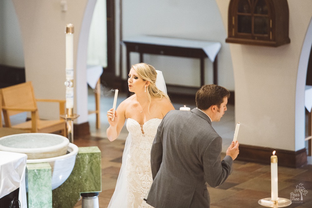 Bride + groom blowing out individual candles after lighting unity candle.