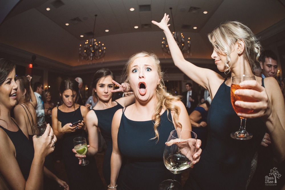 Celebrating bridesmaids dancing, drinking, and snapchatting.