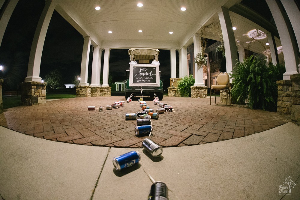 Atlanta Country Club golf cart with Just Married sign on back and beer cans trailing on ribbons behind it.
