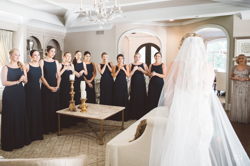 Bridesmaids and mother-in-law to be react to seeing bride in gown for first time.