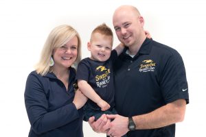 Holly + Peter Ranney from non-profit organization Sunshine on a Ranney Day smiling with their son