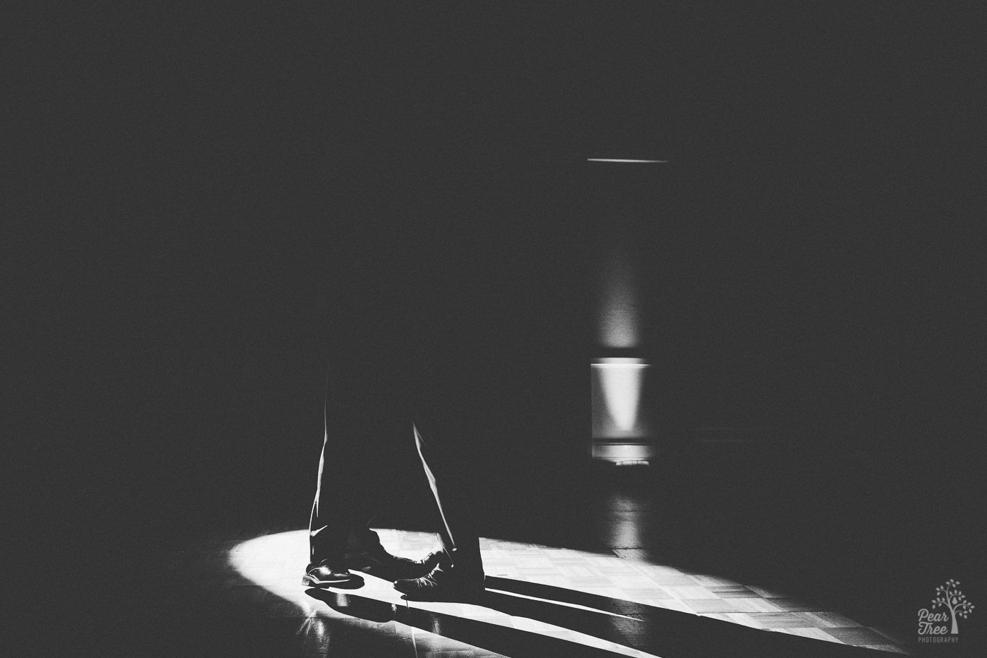 Grooms feet in spotlight during first dance.