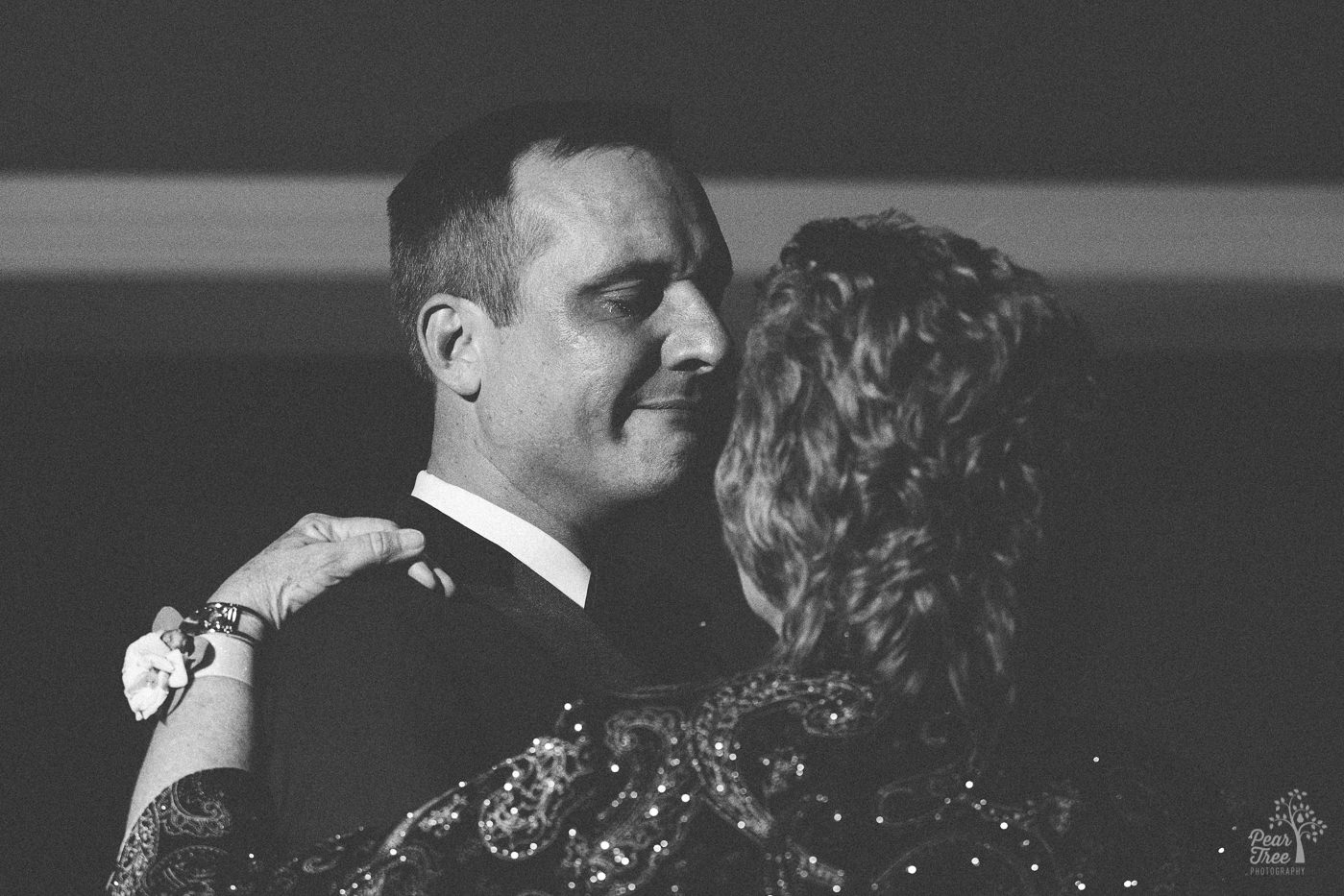 Groom crying during Mother Son dance.