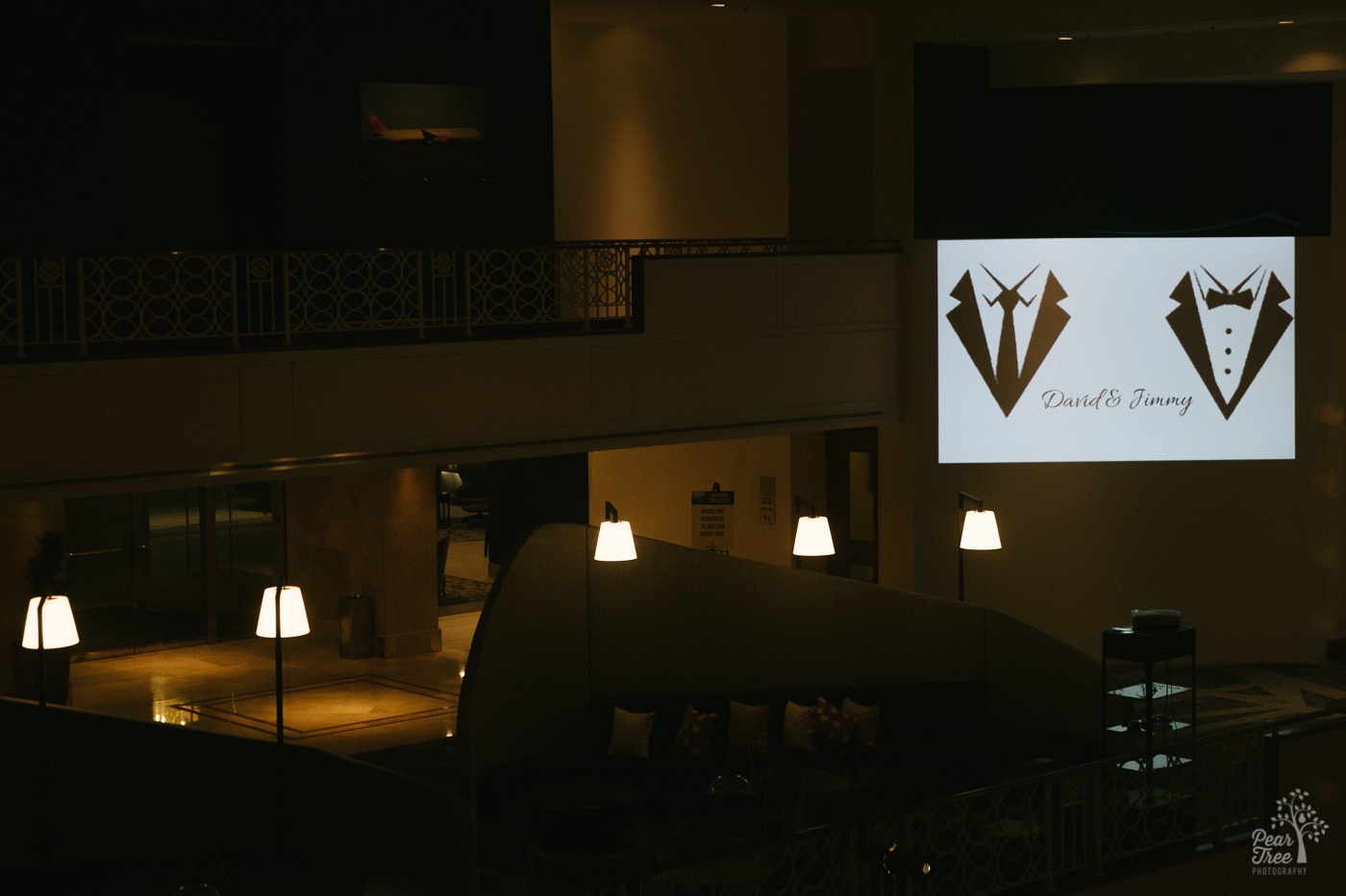 David + Jimmy's wedding logo on Renaissance Concourse Atlanta Airport Hotel lobby wall.