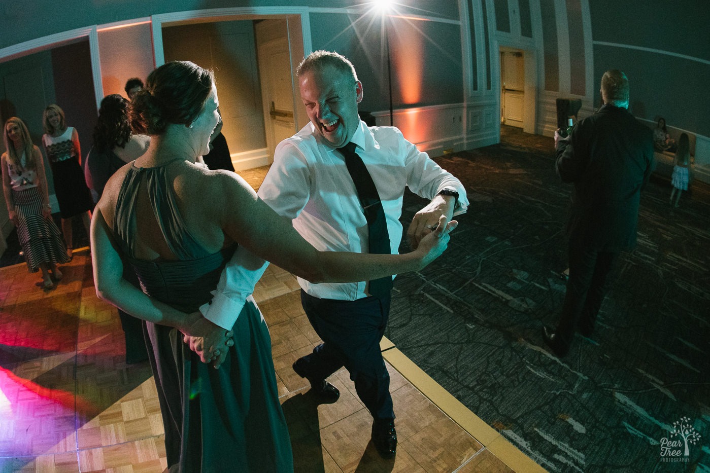 Groom dancing with maid of honor.