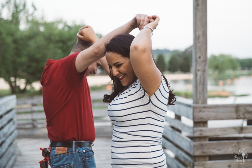 Smiling Algerian-American couple dancing on Lake Acworth boardwalk