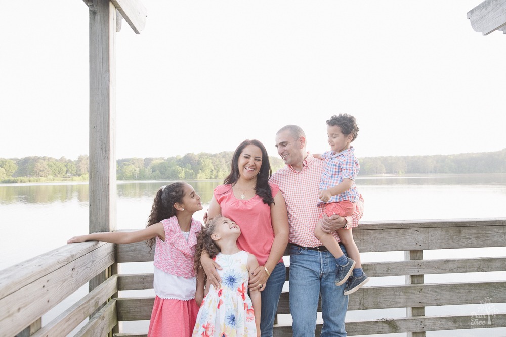 Algerian-American family holding each other close on the deck at Lake Acworth.