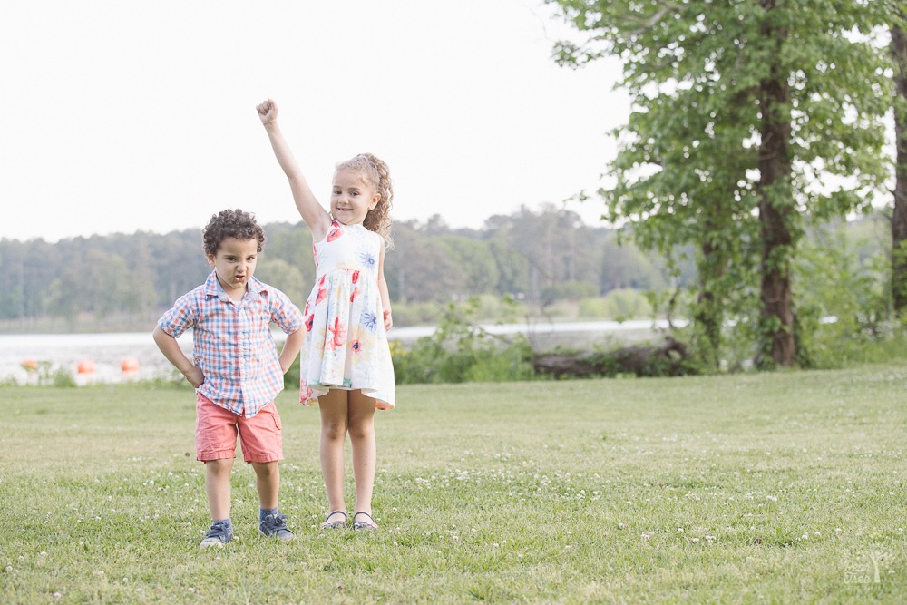 Little brother playing tough and big sister playing Superman.