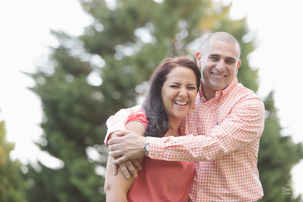 Happy couple hugging and laughing