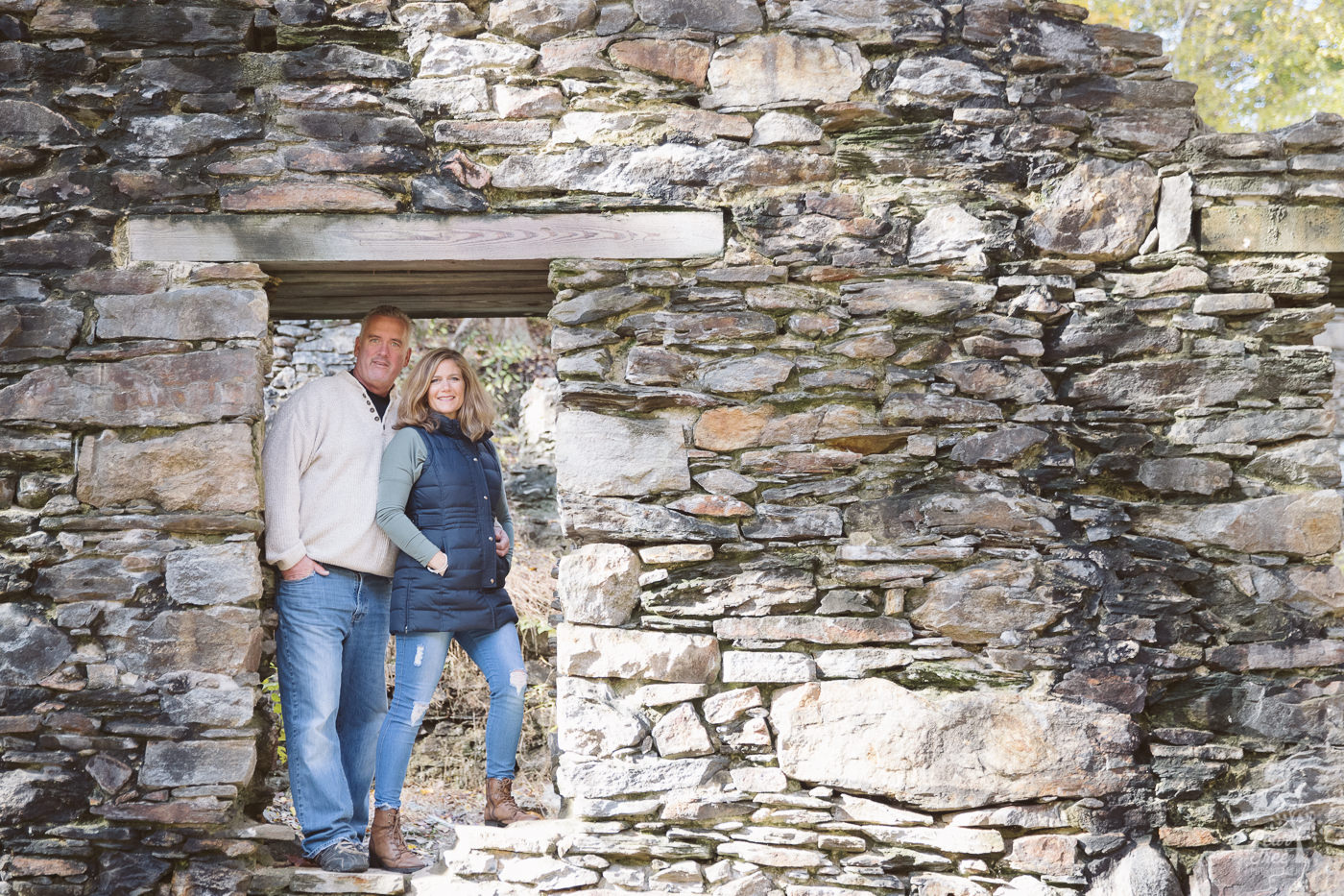 Husband and wife standing together in paper mill ruins doorway at Sope Creek.