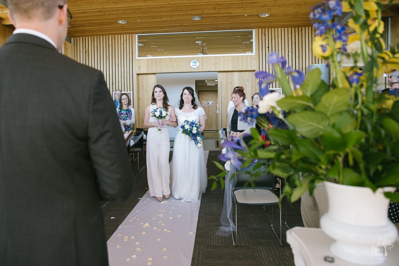 A beautiful daughter walking her gorgeous mom down the wedding aisle at her mom's wedding in Embry Riddle Chapel.