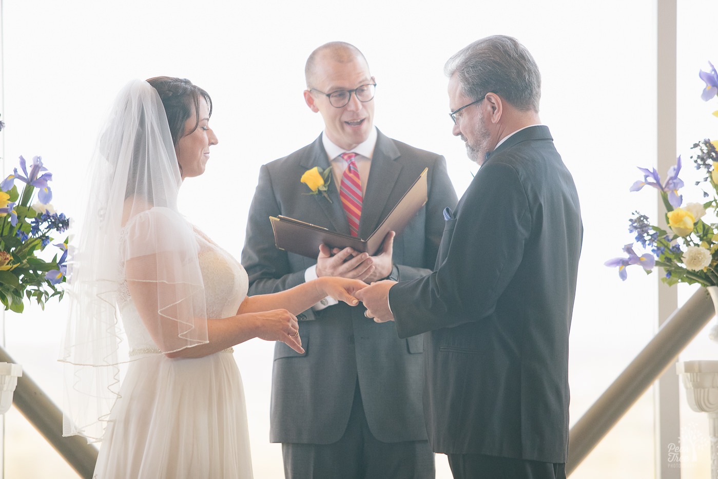 This bride and groom exchanged rings as they got married in Embry Riddle Chapel in Arizona.