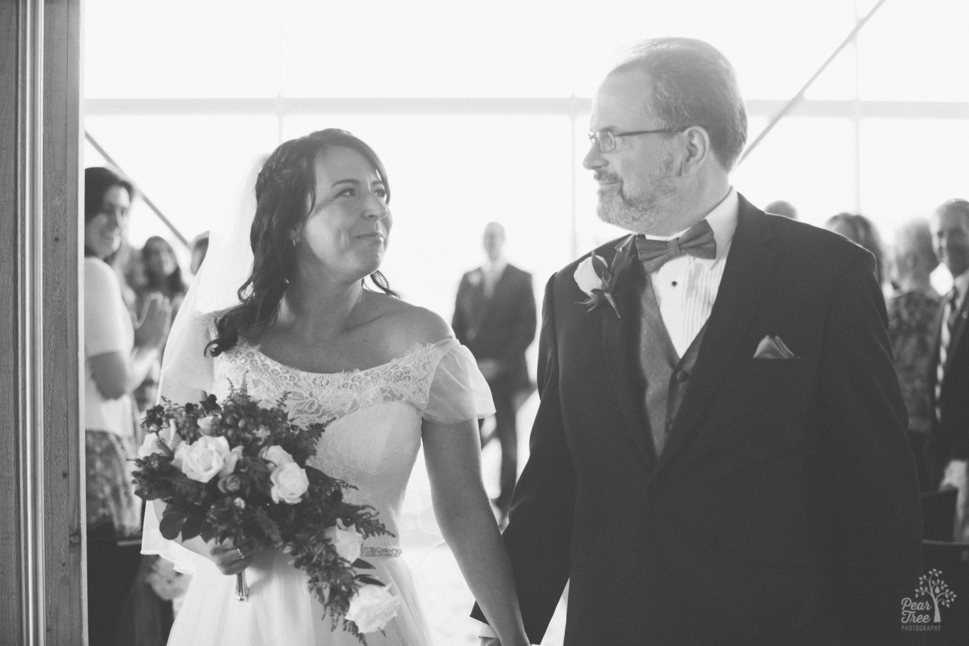 A bride and groom walking hand in hand after they got married in the Embry Riddle Chapel in Arizona.