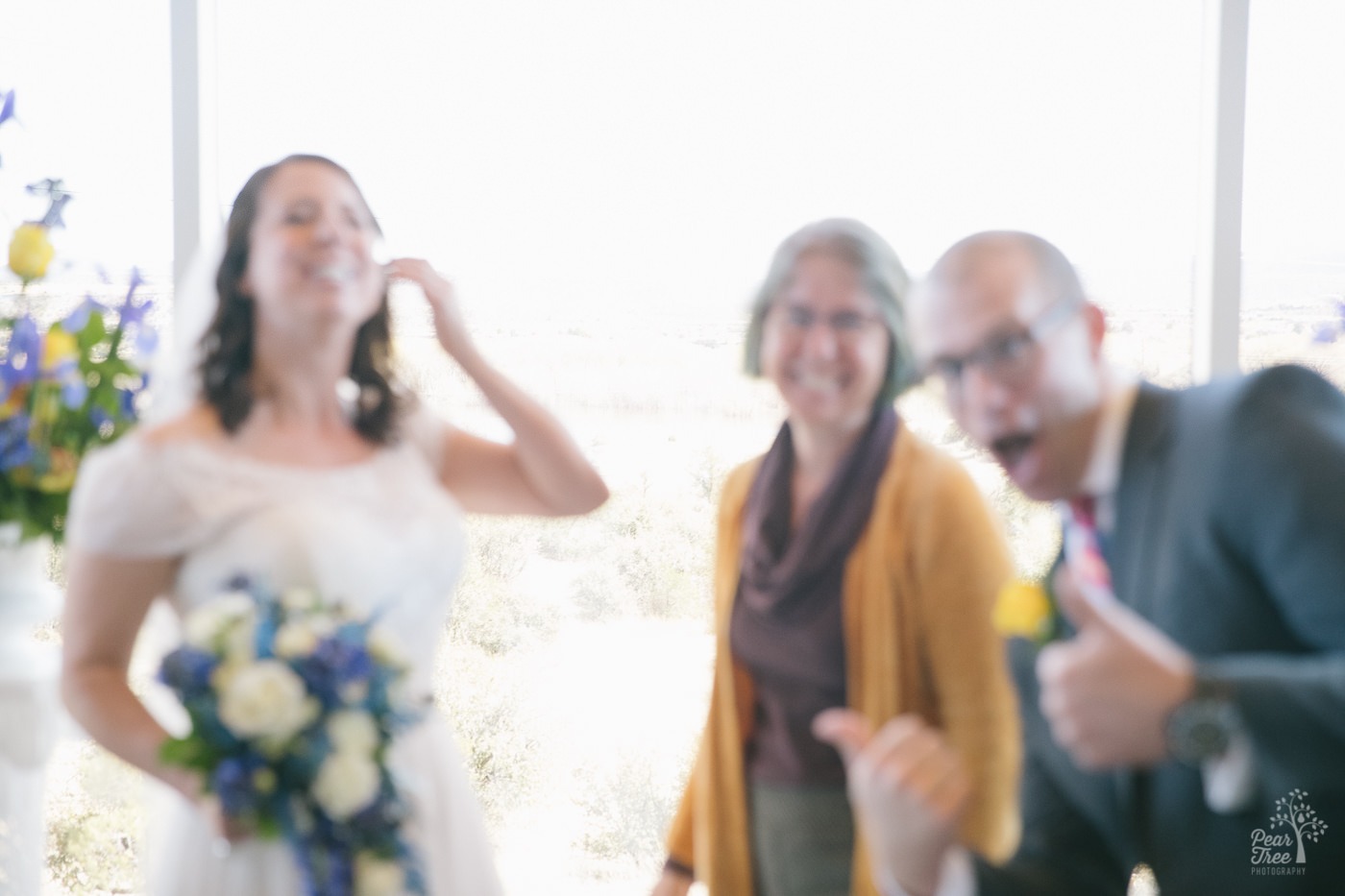 When a wedding photographer hands off her camera to be included in wedding formals, this is the resulting out-of-focus photograph