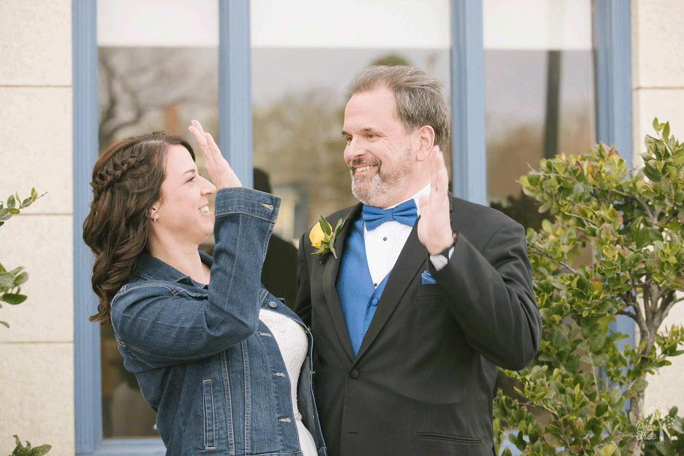 Bride and groom reenacting their high five after their wedding ceremony when in under one minute they got married at Embry Riddle Chapel.