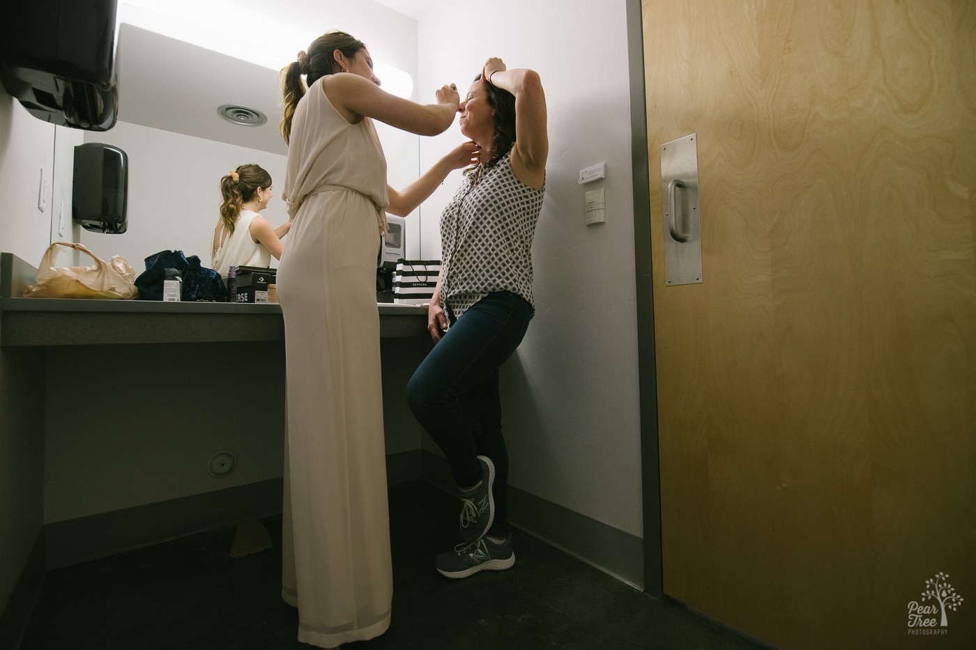 College daughter doing her mom's wedding day makeup.