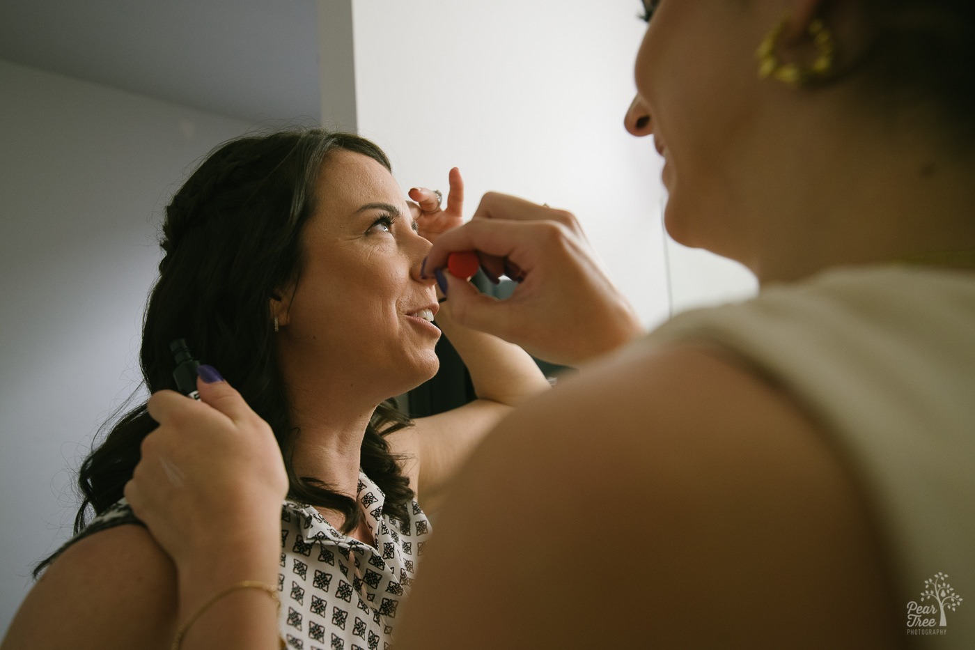 College daughter doing her mom's wedding makeup.