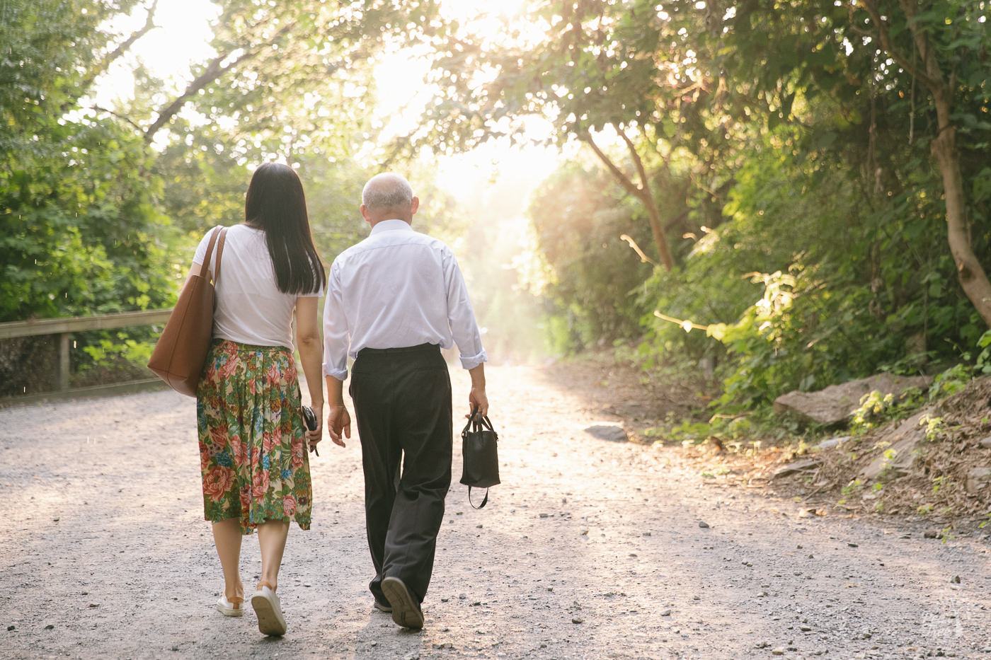 Chinese father and daughter walking through the rain towards Roswell Mill as the sun came back out.