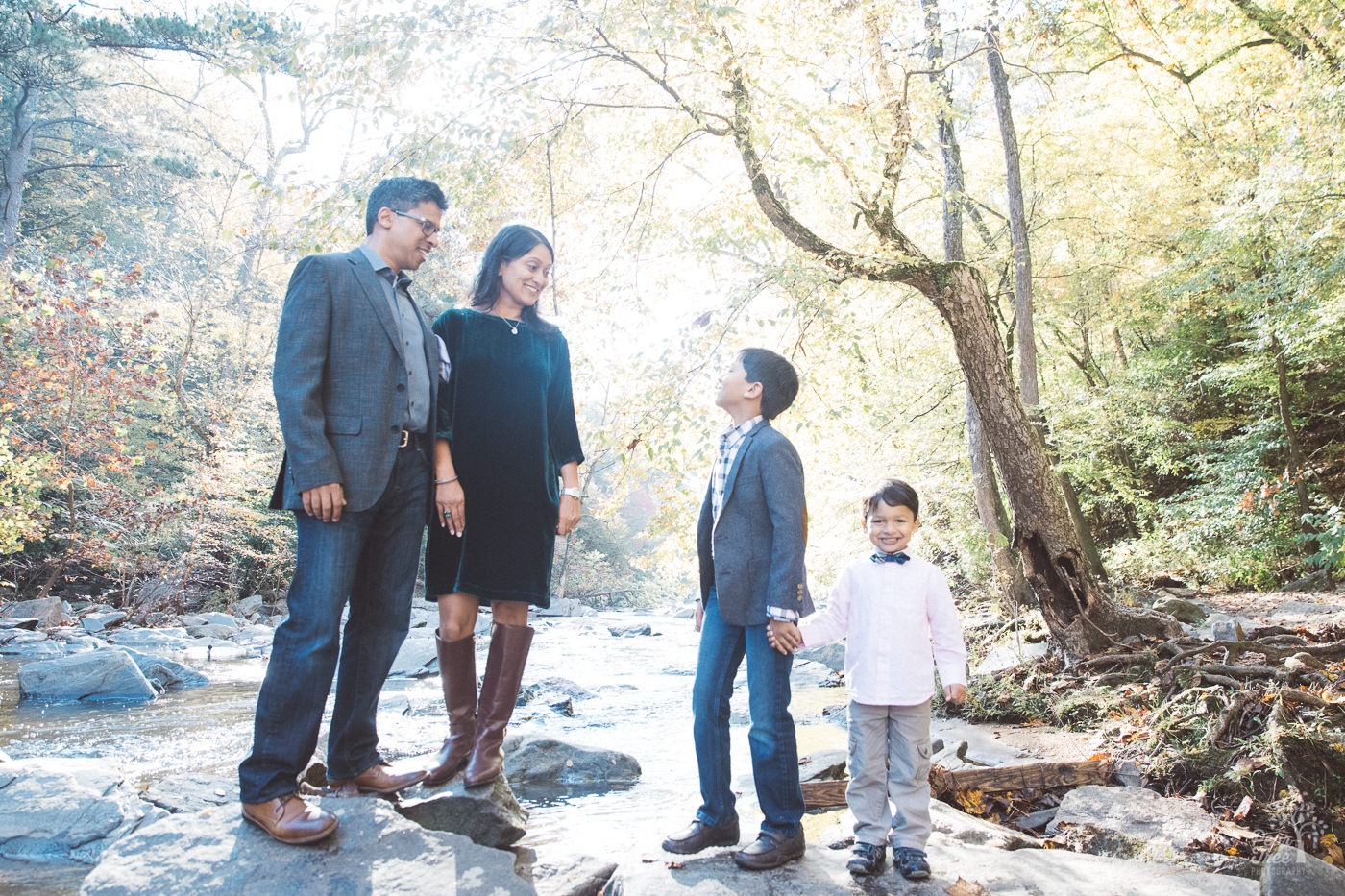 Family of four standing on shoals at Sope Creek.