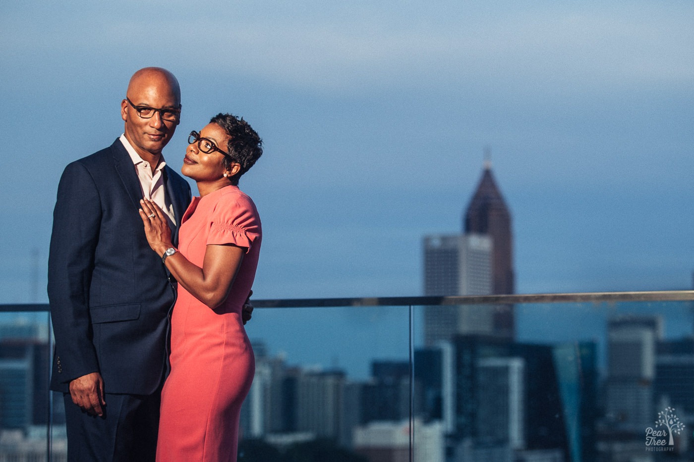 Power shot of engaged couple in Atlanta skyline from 18th floor balcony in midtown.