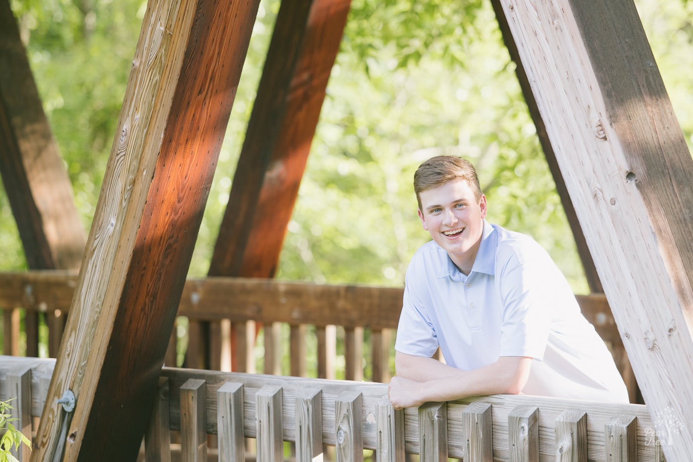 Woodstock High School senior standing in the Roswell Mill covered bridge.