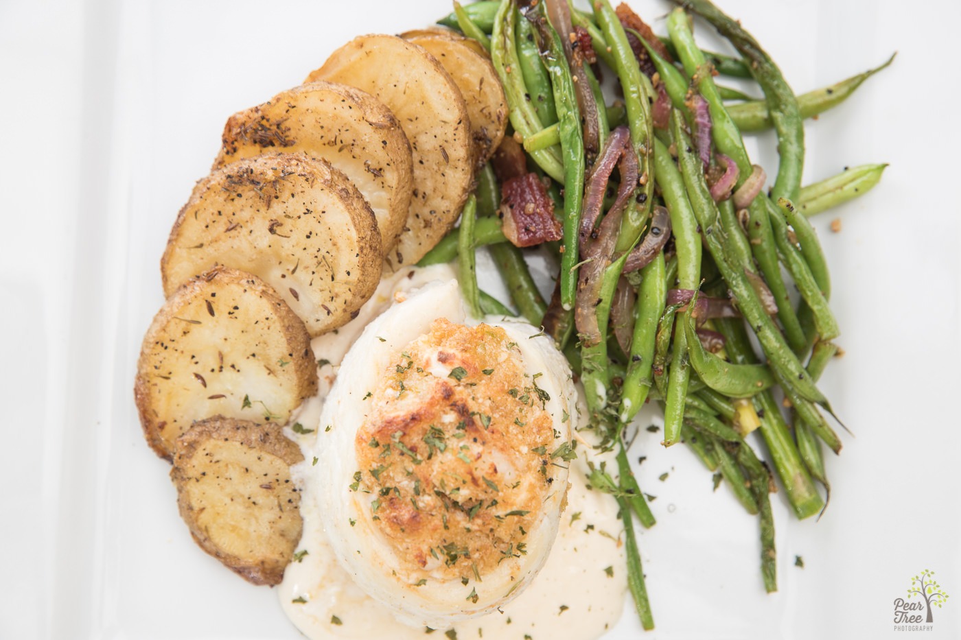 Stuffed tilapia, potatoes, and seasoned green beans with onions crafted by Divine Taste of Heaven.