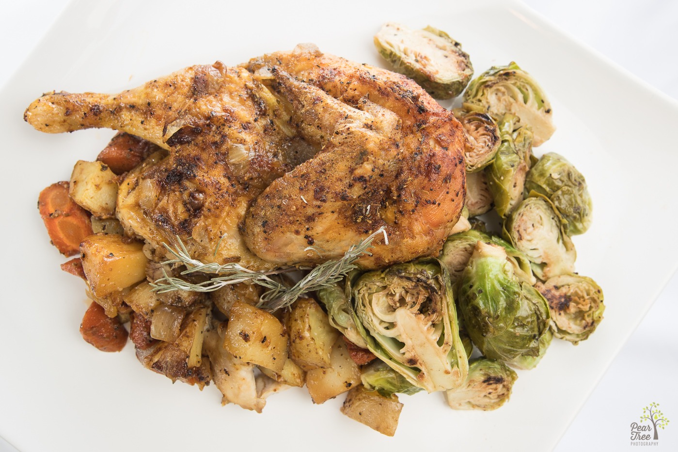 Roasted chicken with brussel sprouts, carrots, and potatoes made by caterer Divine Taste of Heaven.