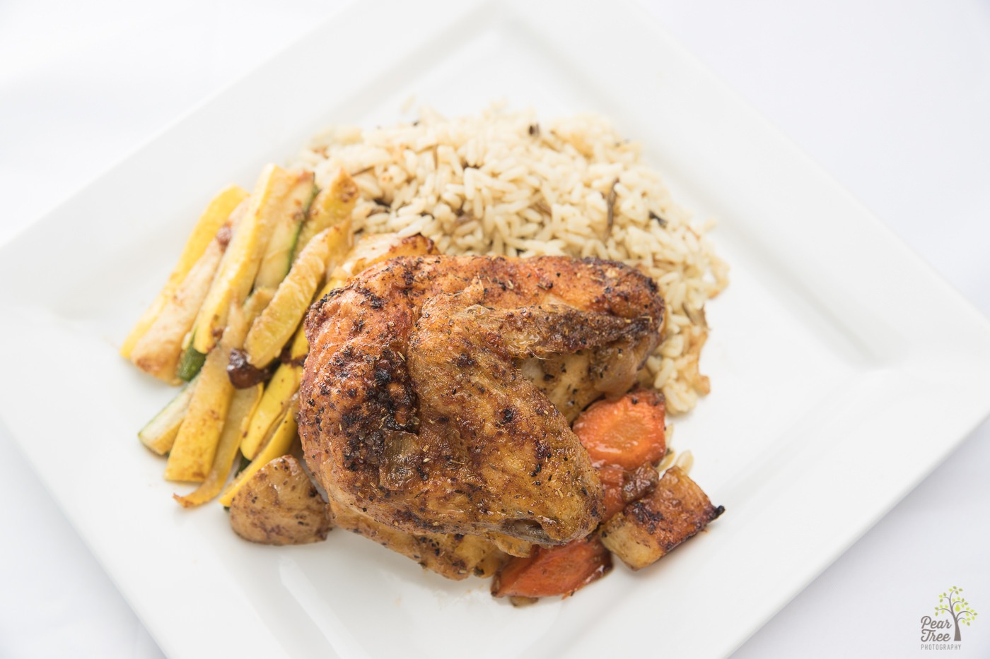 Baked chicken with zucchini, rice pilaf, and sweet carrots catered by Divine Taste of Heaven.