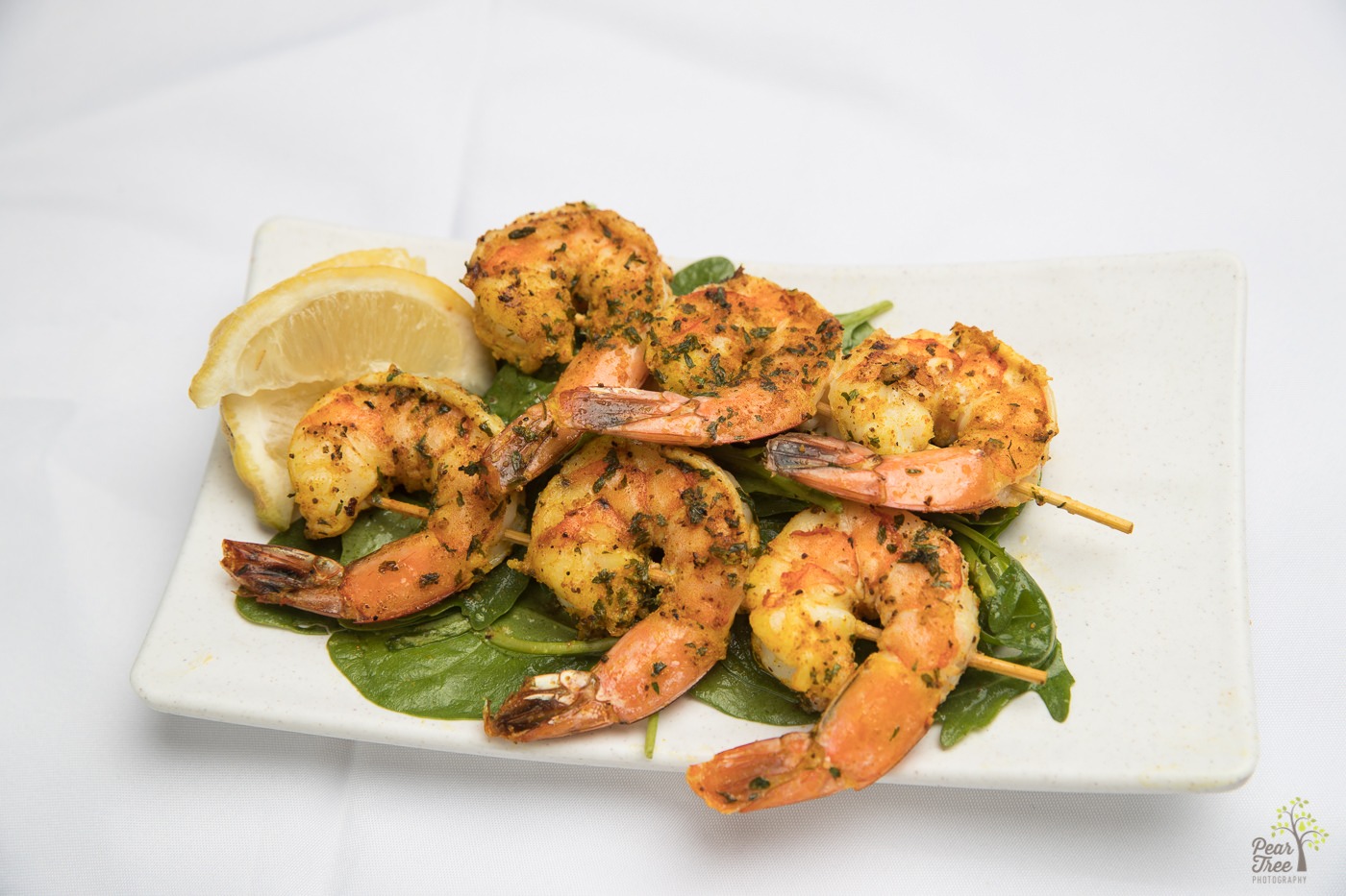 Cajun skewered shrimp with lemon slices prepared by Divine Taste of Heaven caterer.