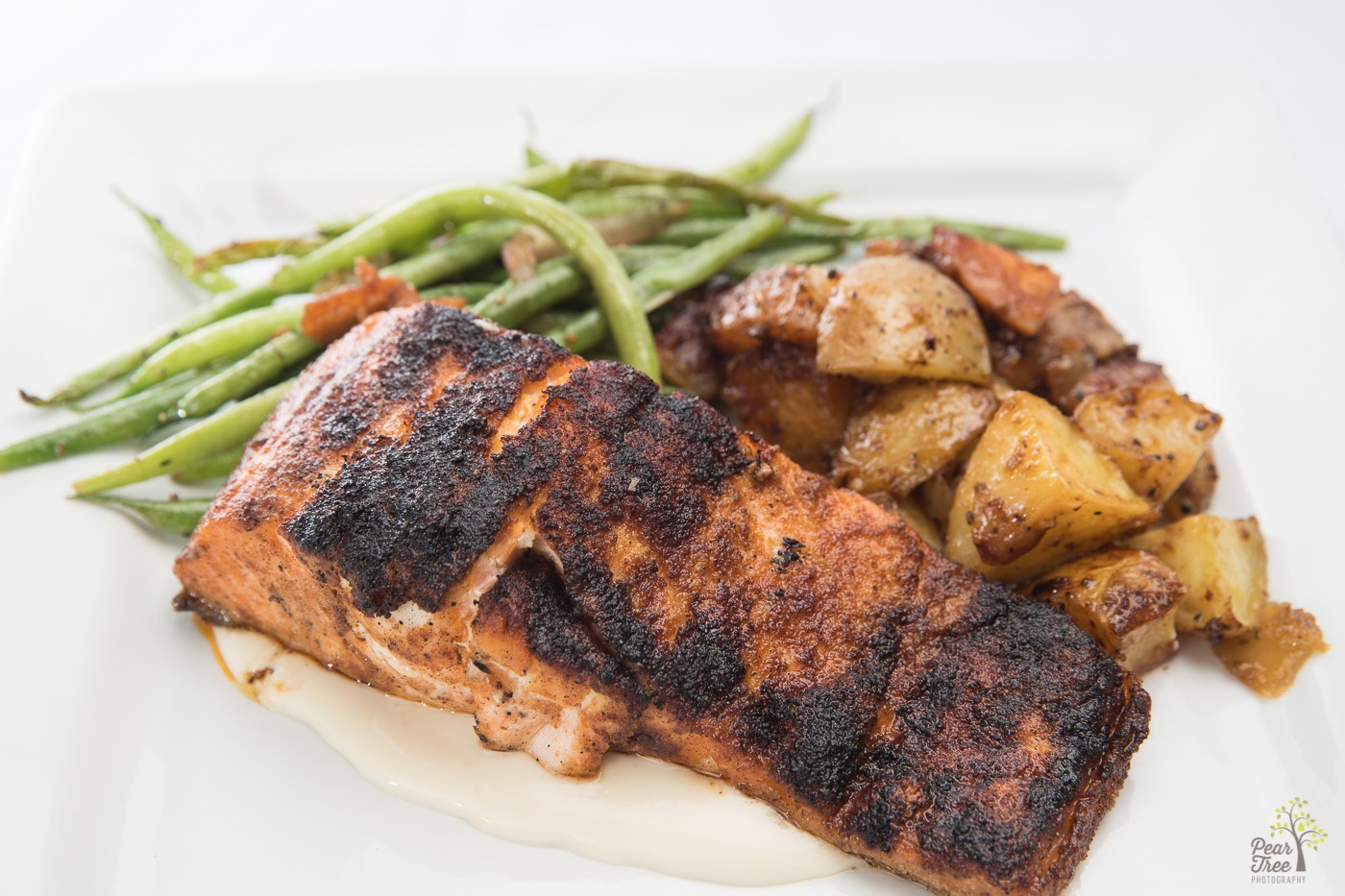 Baked cajun salmon served with fresh green beans and roasted potatoes catered by Divine Taste of Heaven.