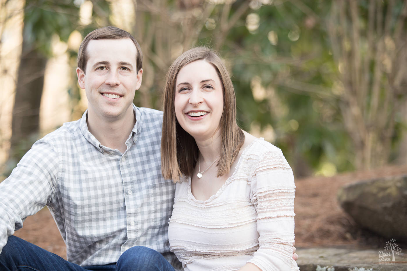 Smiling married couple in downtown Woodstock park.