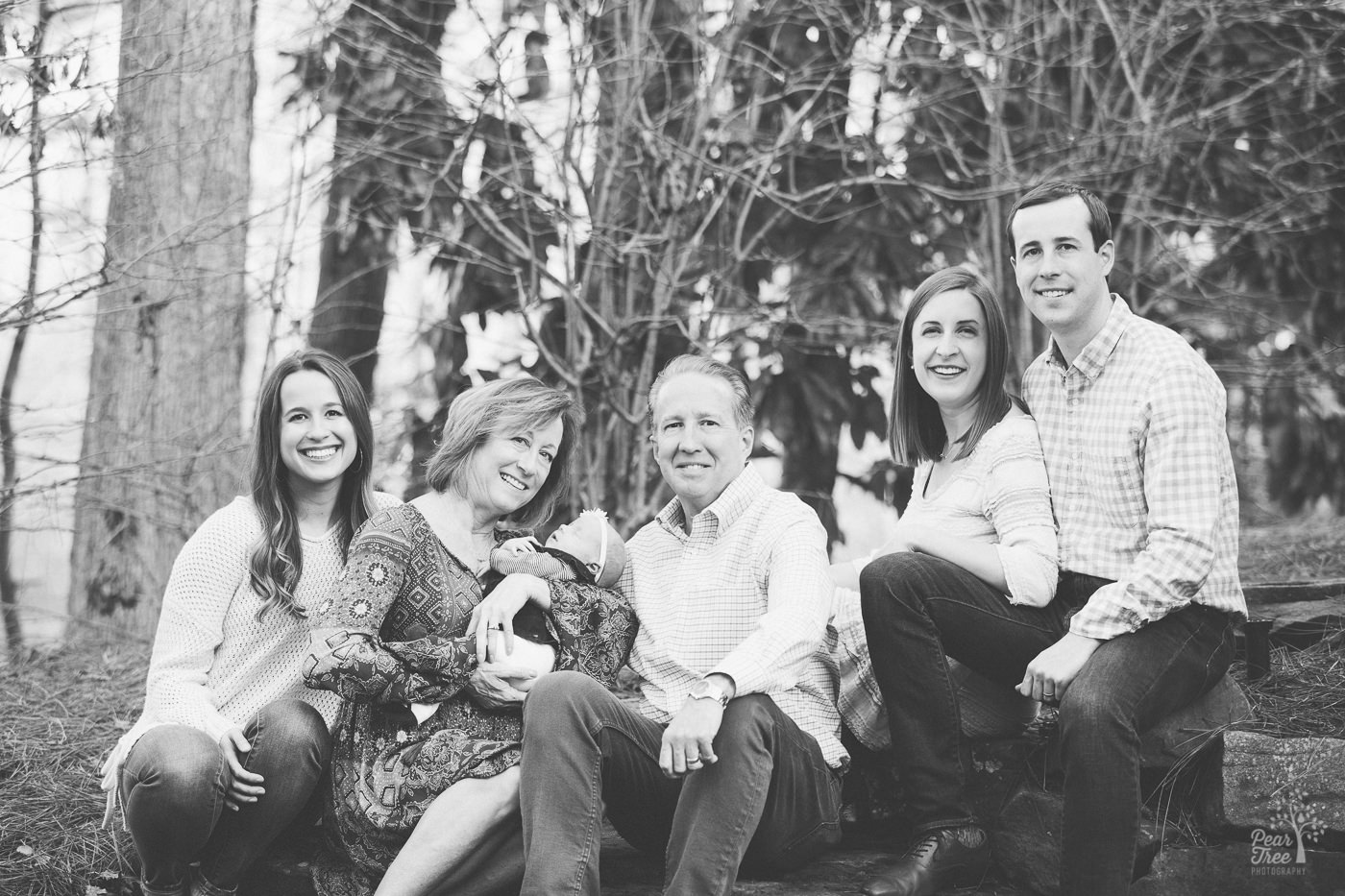 Black and white photograph of three generations of one family and their newborn granddaughter.