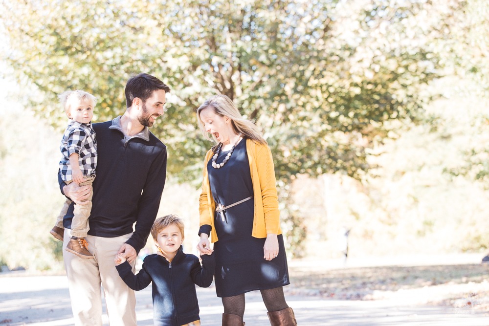 Family of four having fun together walking through Piedmont Park.