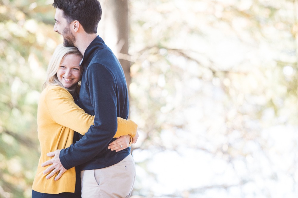 Sweet husband loving on his wife and holding her close while she smiles so big knowing how loved she is.