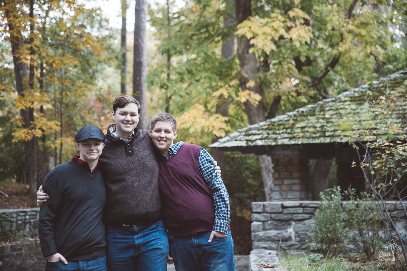 Three teenage brothers squeezing in tight for one last photograph at Stone Mountain park.