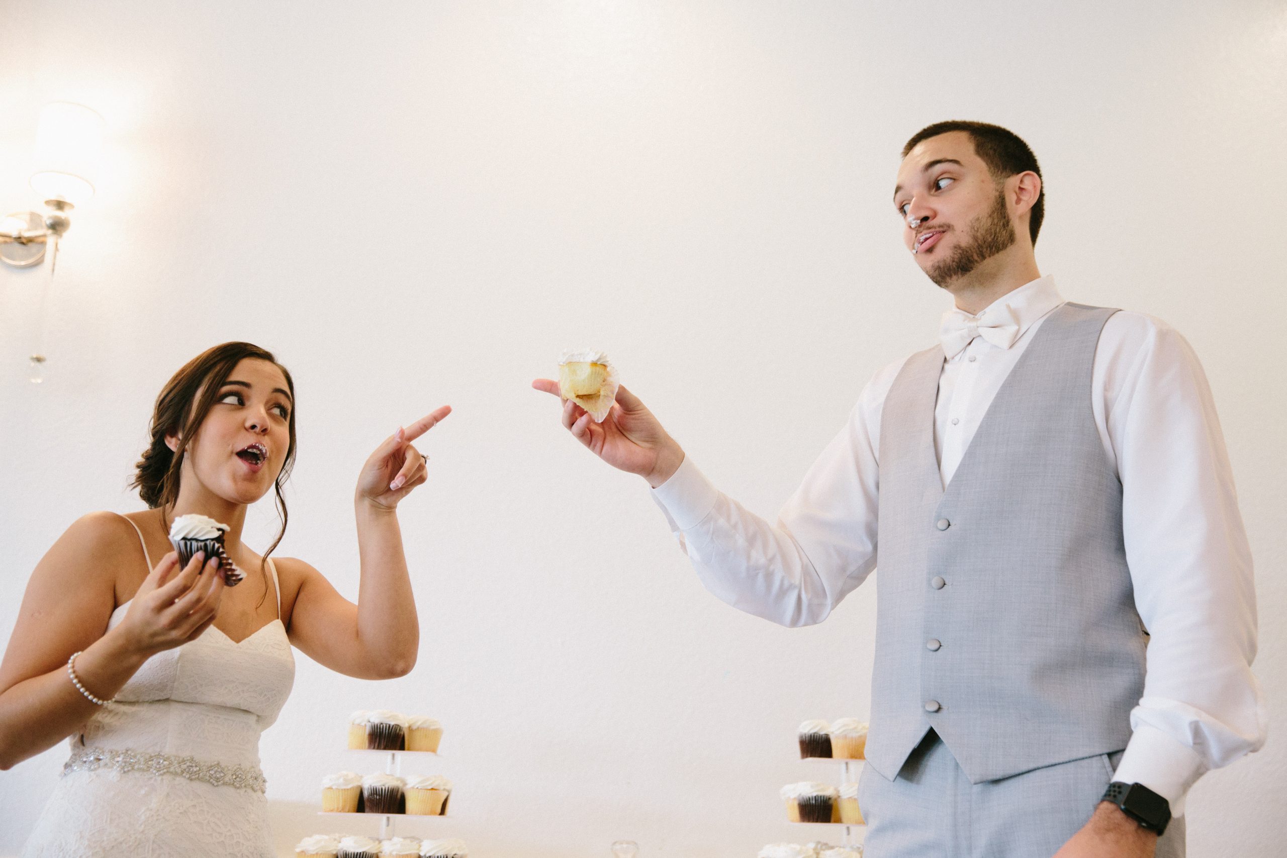 Pear Tree Photography Atlanta bride + groom pointing fingers of warning at each other over cake exchange at their destination wedding