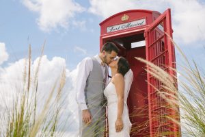 Gorgeous bride + groom kissing in front of Royal Crest Room red phone book