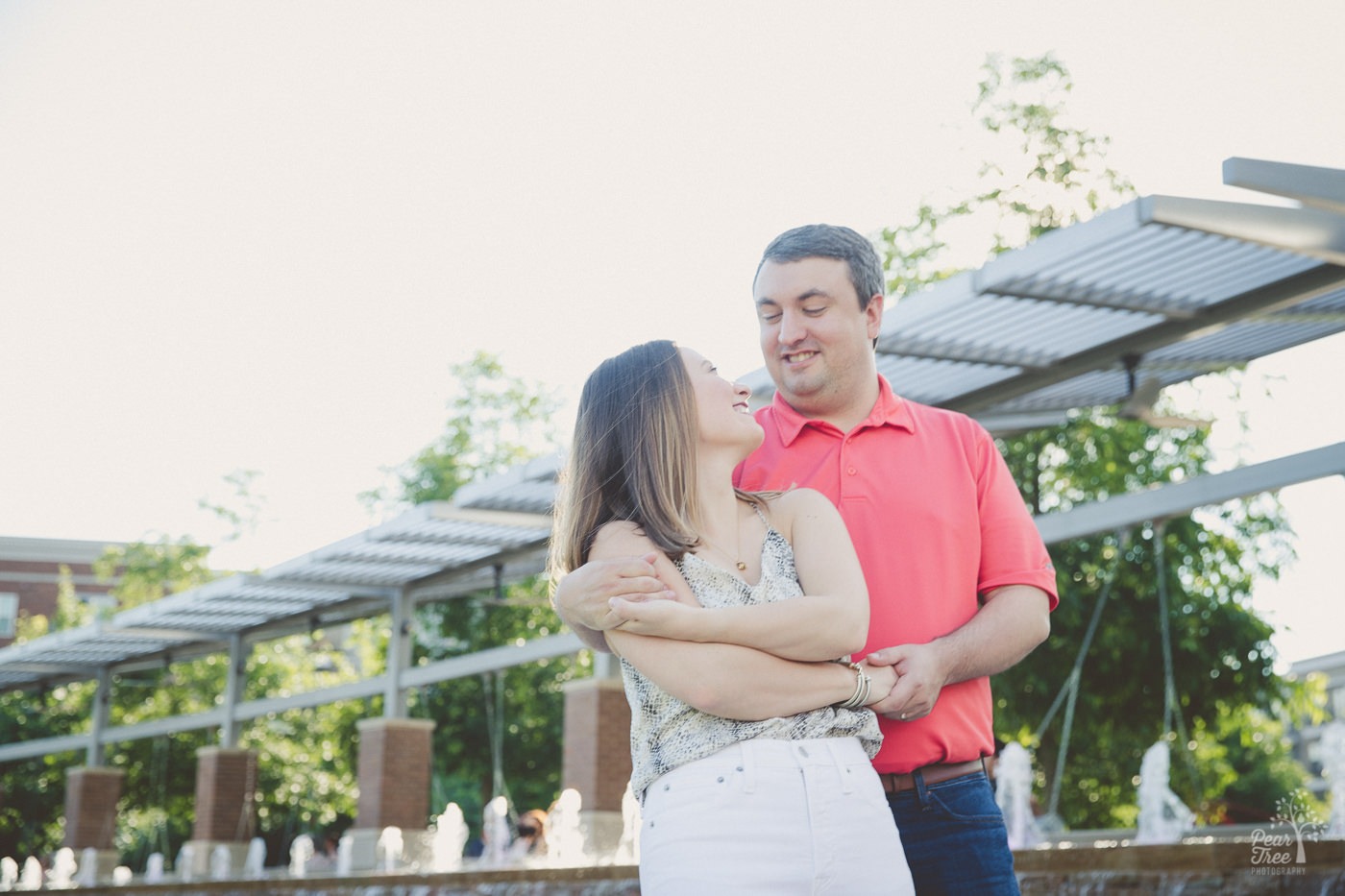 Sweet couple pulling close after a dance twirl and smiling at each other