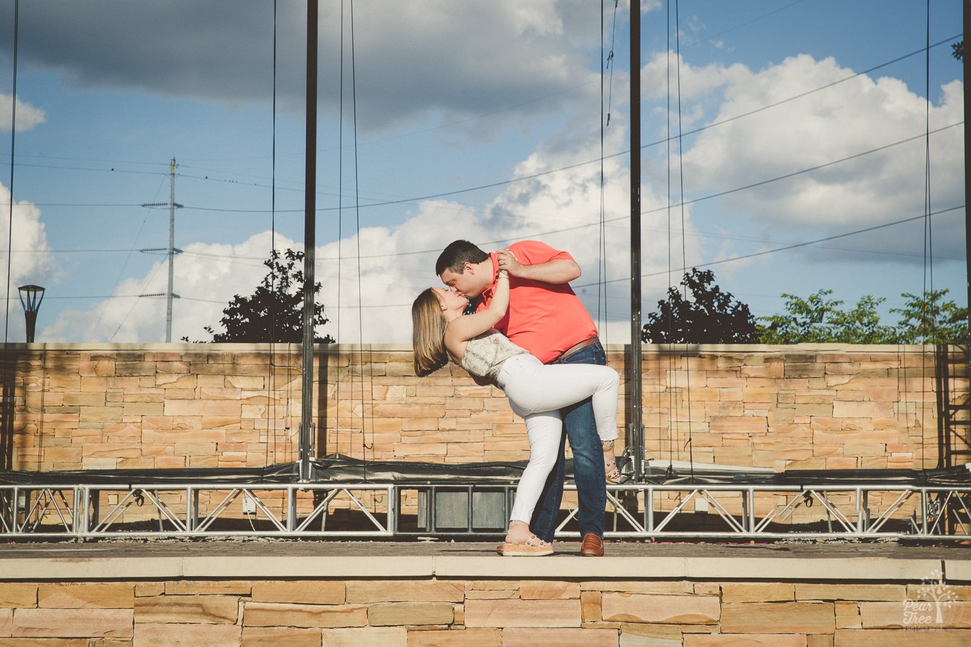 Sweet husband dipping his wife for a kiss on City Springs amphitheatre stage