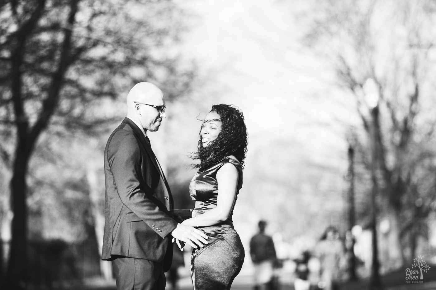 Black and white photograph of an African American couple holding hands and smiling in Piedmont Park