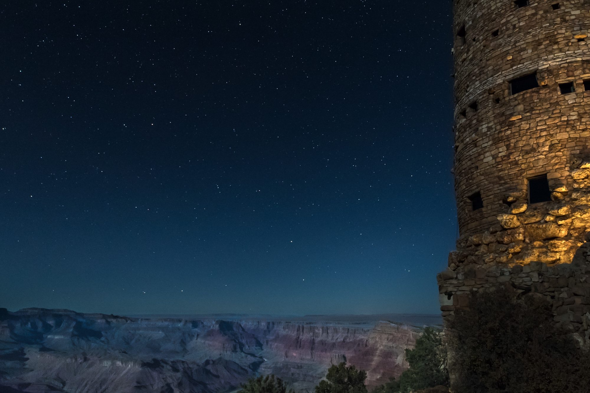 Grand Canyon Watch Tower in the middle of the night with more stars in the night sky than FAQs to be answered