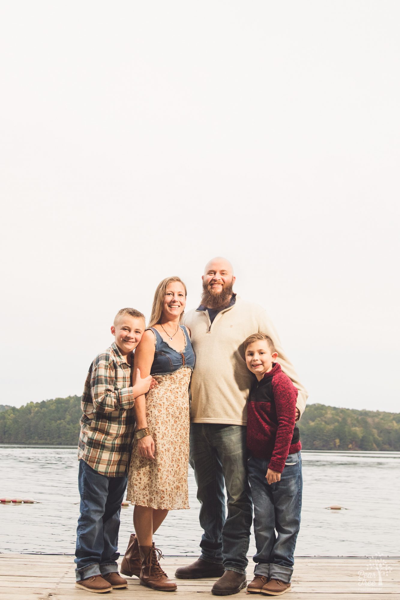 Smiling family of four with sons behaving nicely on Lake Arrowhead dock