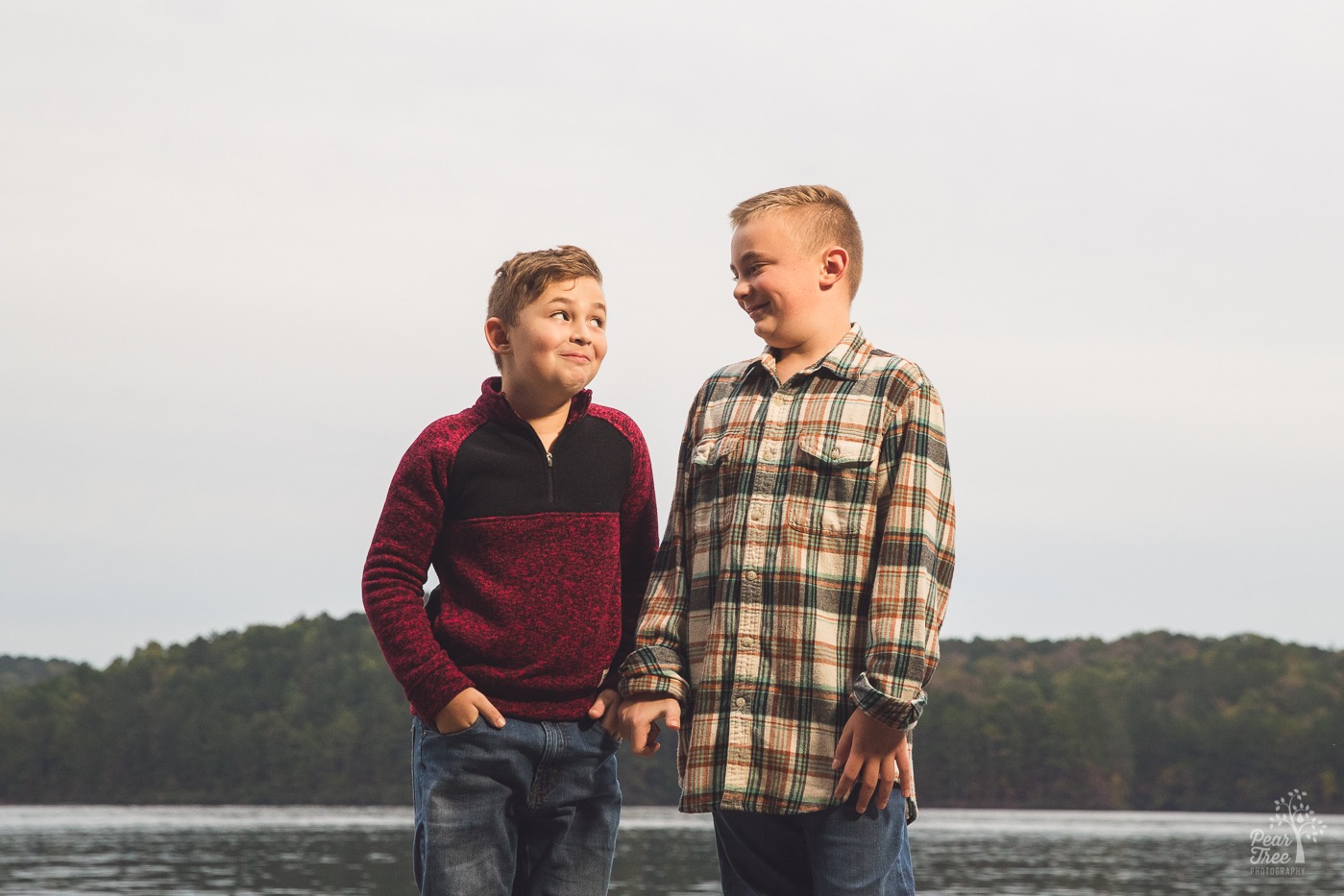 Two young brothers smiling and behaving side by side at Lake Arrowhead