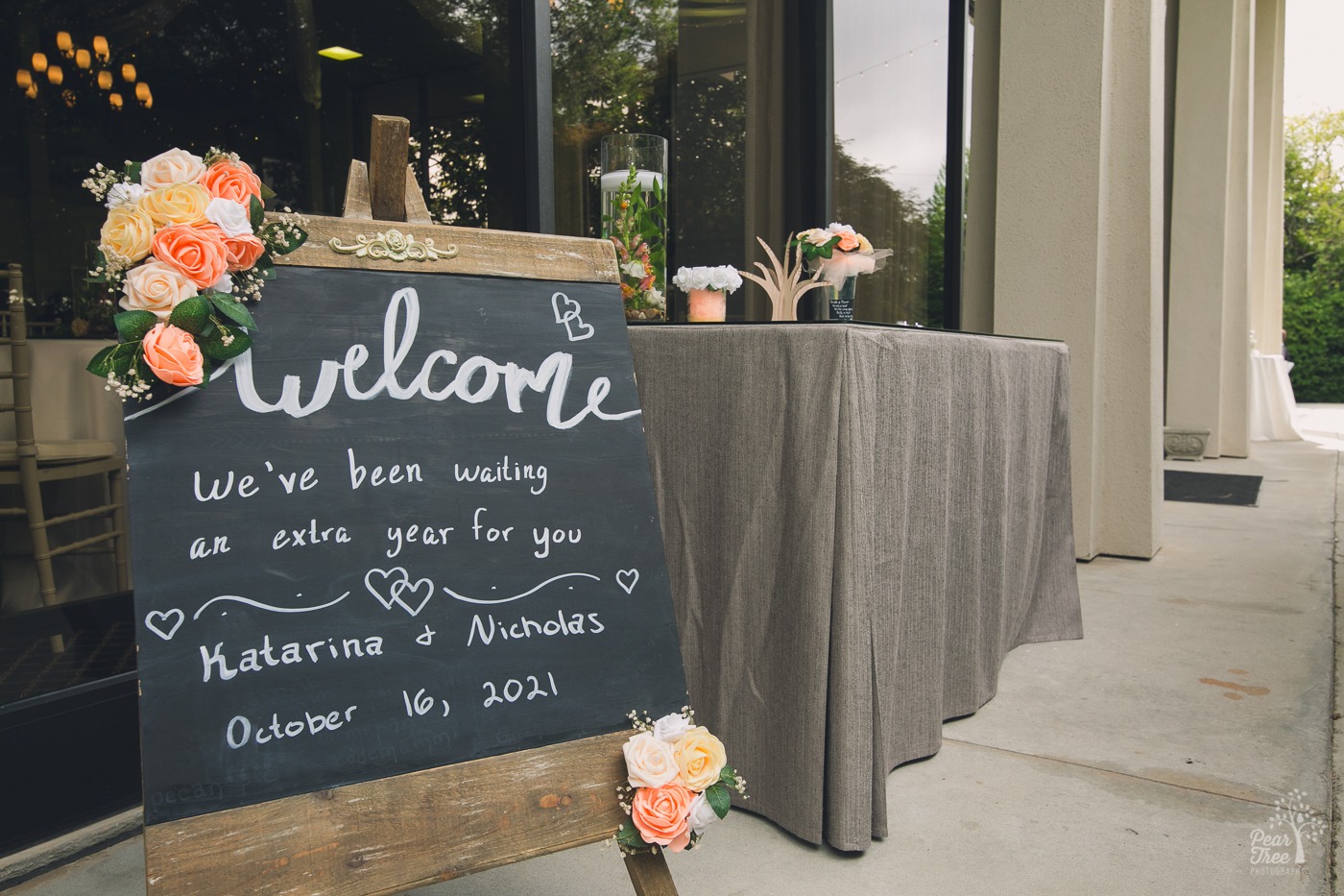Chalkboard sign outside The Atrium welcoming wedding guests after waiting an extra year because of the pandemic