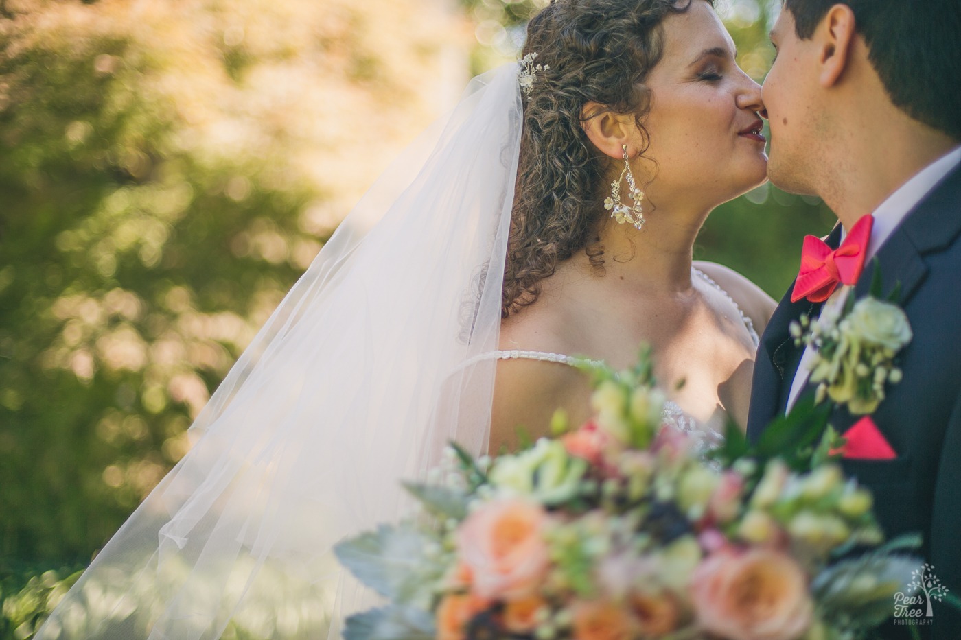 Atlanta wedding couple almost kissing each other outside of The Atrium in the garden