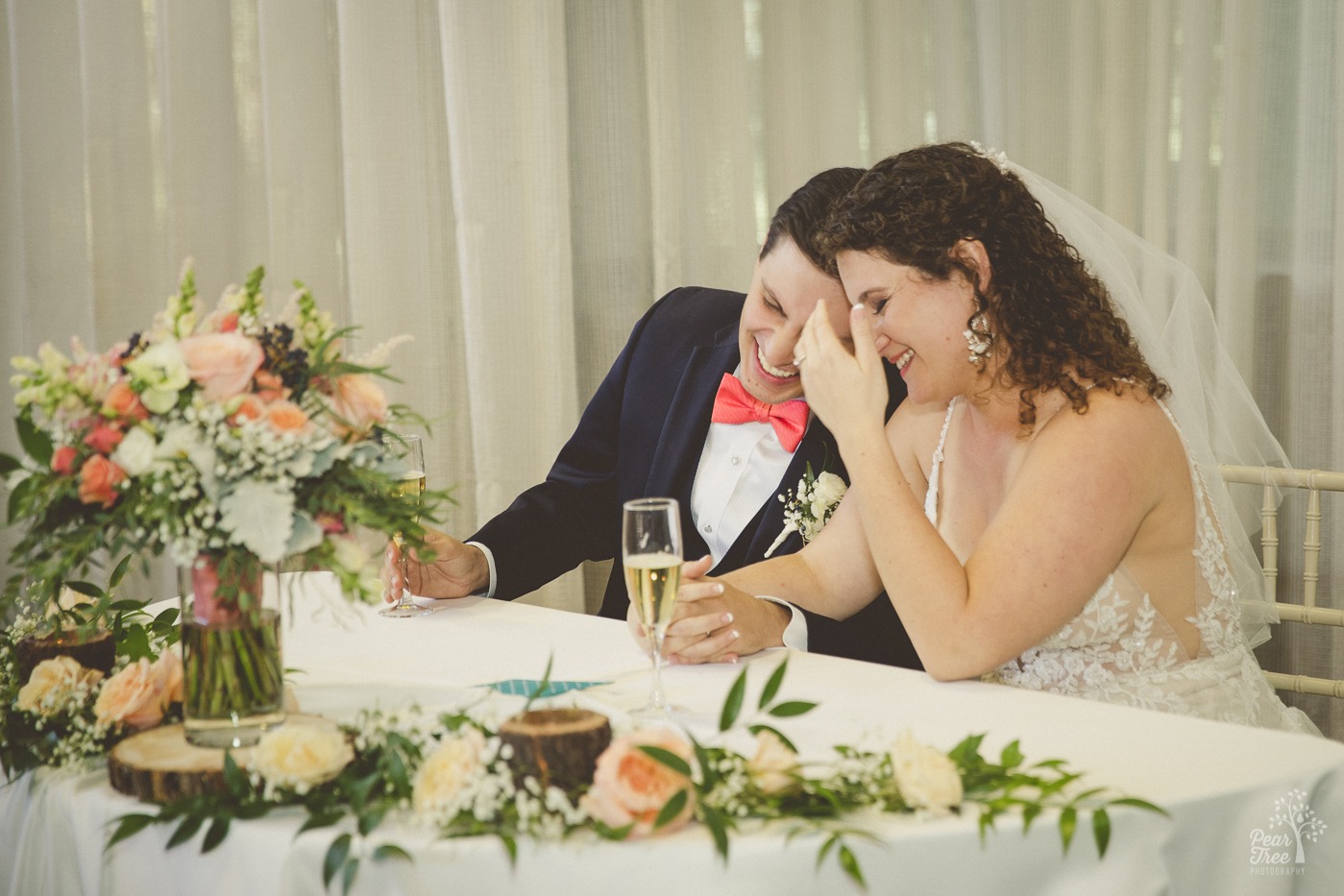 Atlanta wedding couple laughing and bumping into each other during a toast