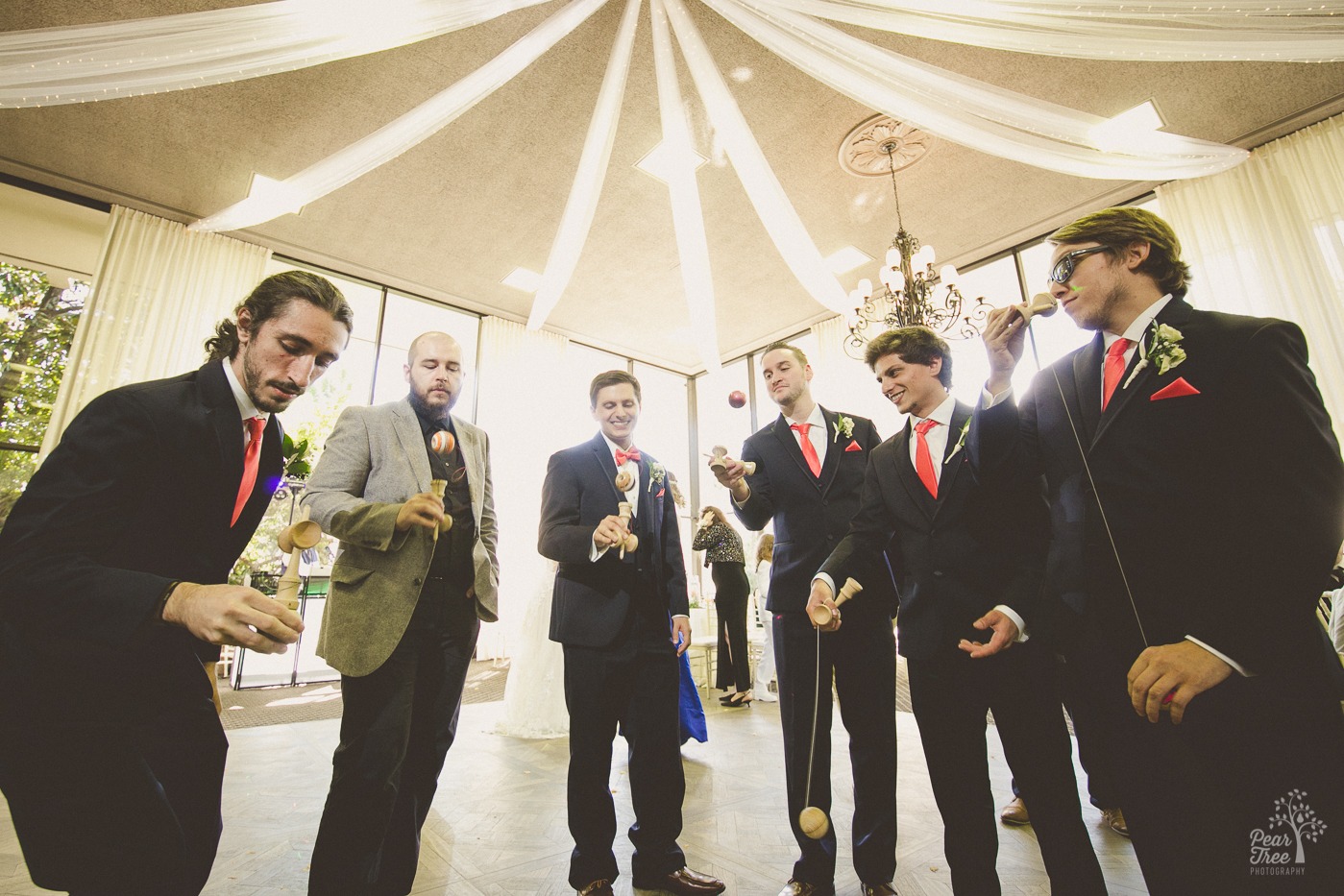 Georgia kendama players turning tricks in Atlanta wedding party inside The Atrium