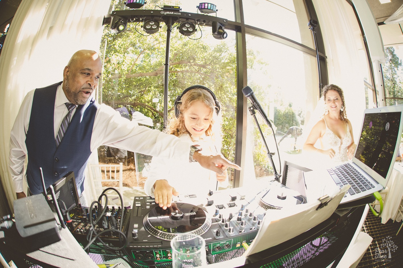 Atlanta wedding DJ showing bride's younger brother how to spin some tunes at The Atrium